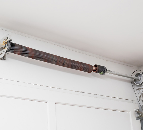 garage door spring mechanism with adjustment features for three different levels of tension