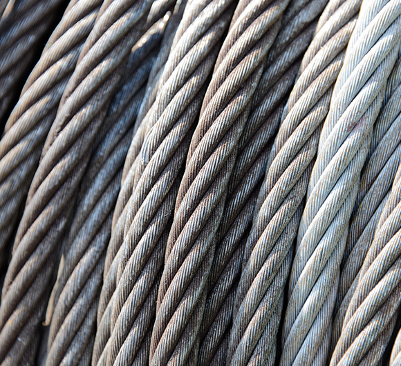 close-up of tightly coiled metal cables highlighting various shades of gray suitable for use in industrial applications such as construction and rigging five key features of strength and durability